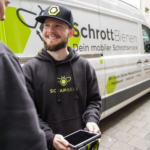ScrapBees team member smiling next to a branded van
