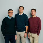 The three male startup founders of 42Watt in casual sweaters, posing against a plain background