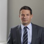 Philipp Haind, BONVENTURE Advisor, facing the camera in a neutral indoor setting.