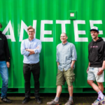 The four Planeteers founders standing in front of a green container with bold lettering